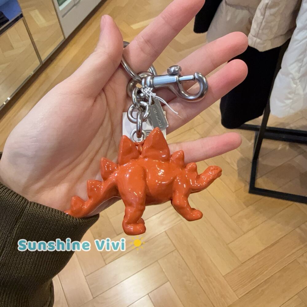 NWT Coach Keychain Stegosaurus dinosaur Bag Charm Silver Orange CEB63 dust bag